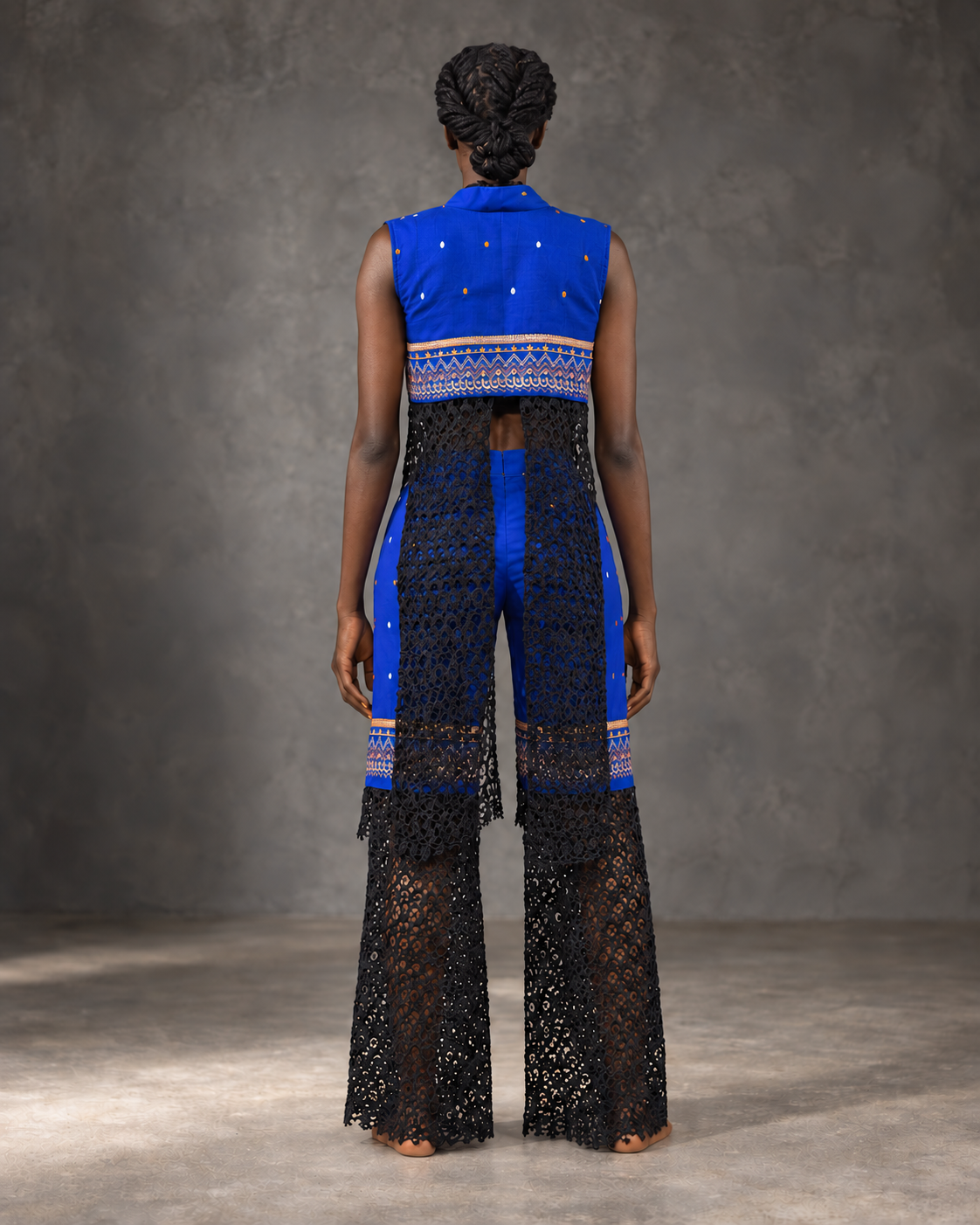 Model wearing the MWAMI Sahel eyelet embroidered lace set, back view showing the lace panels