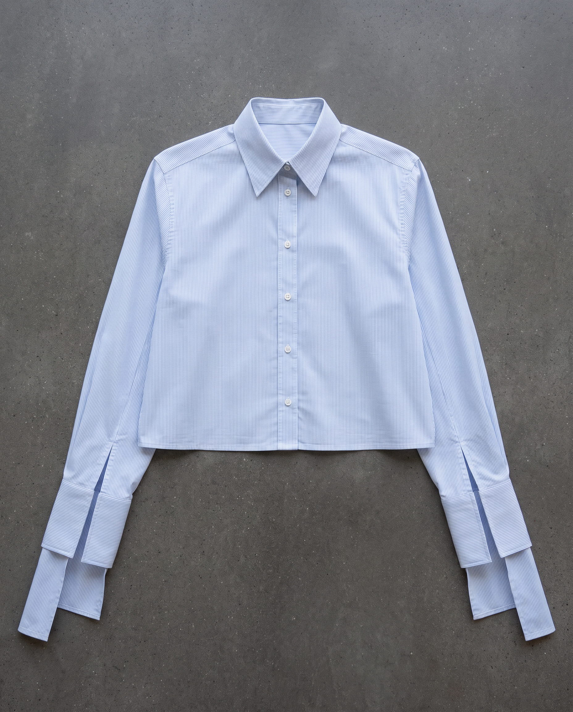 Flat lay of the cropped pinstripe shirt with long tie cuffs