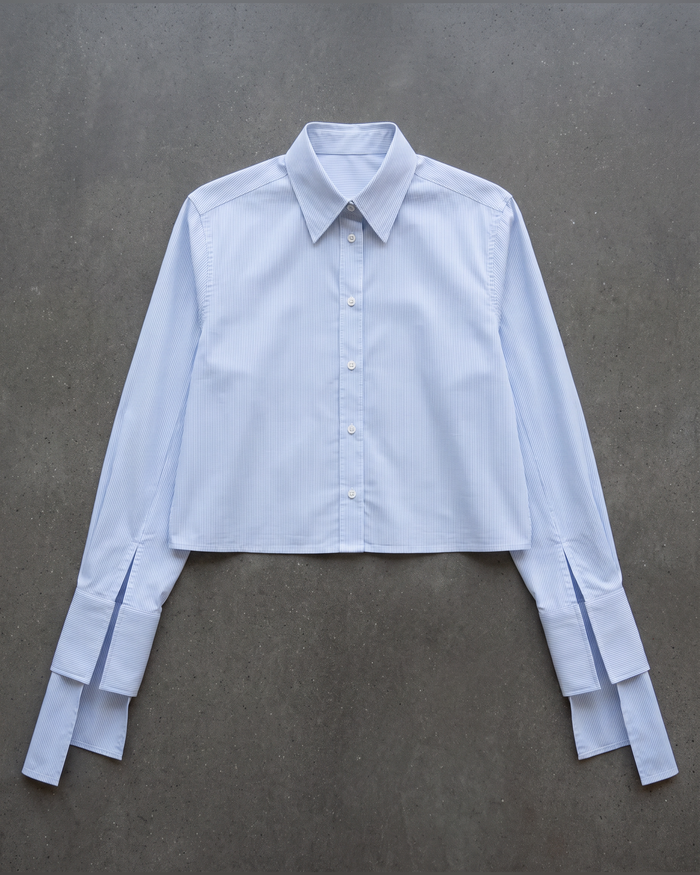 Flat lay of the cropped pinstripe shirt with long tie cuffs