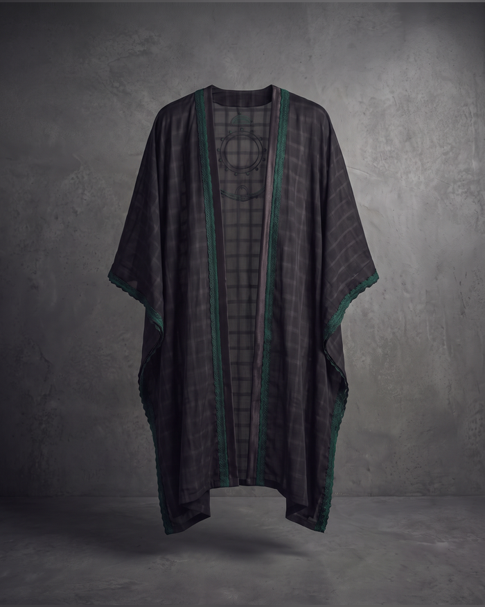 Sheer charcoal plaid cape with green lace trim, flat lay front