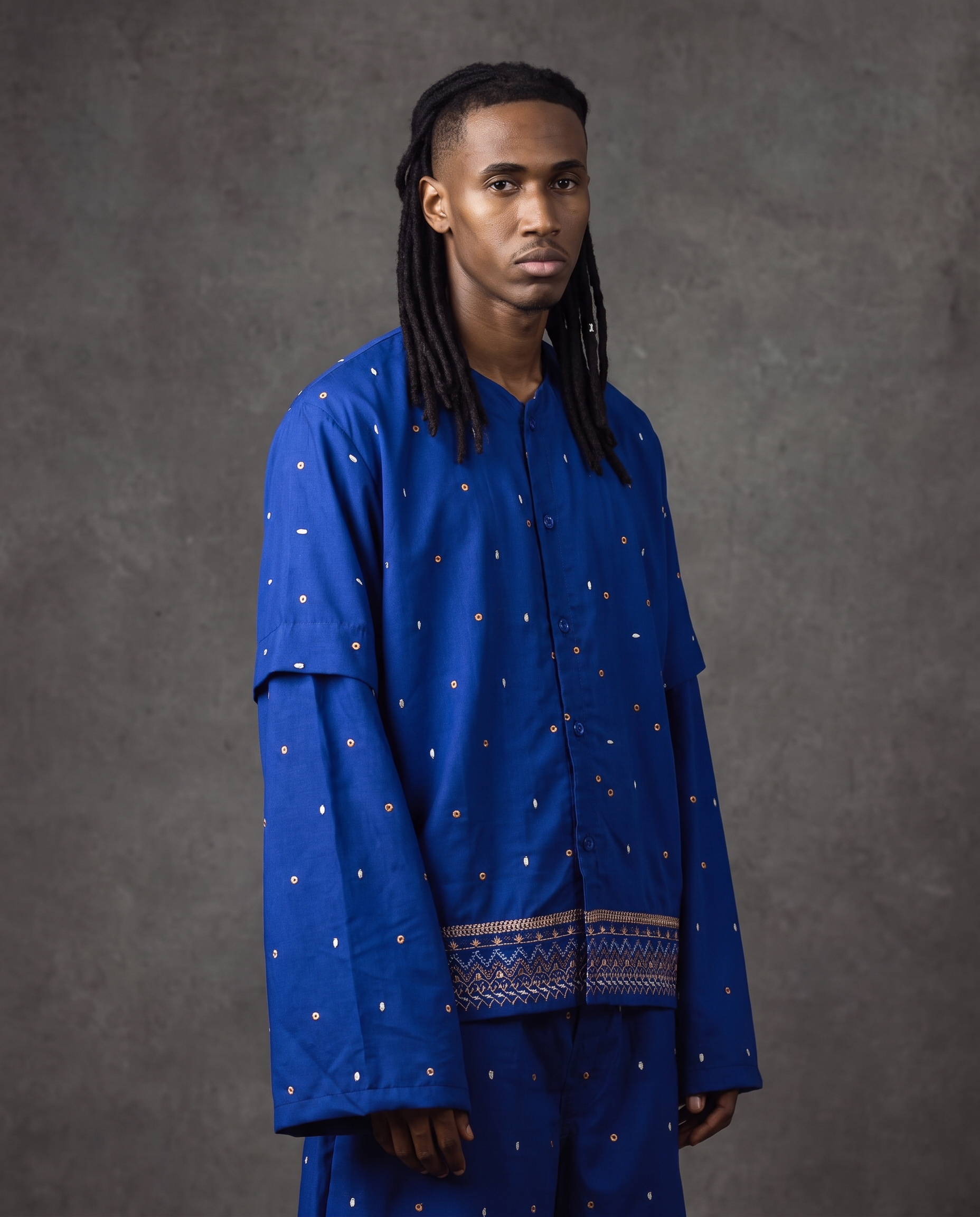 Layered cobalt embroidered shirts and pant, studio side view