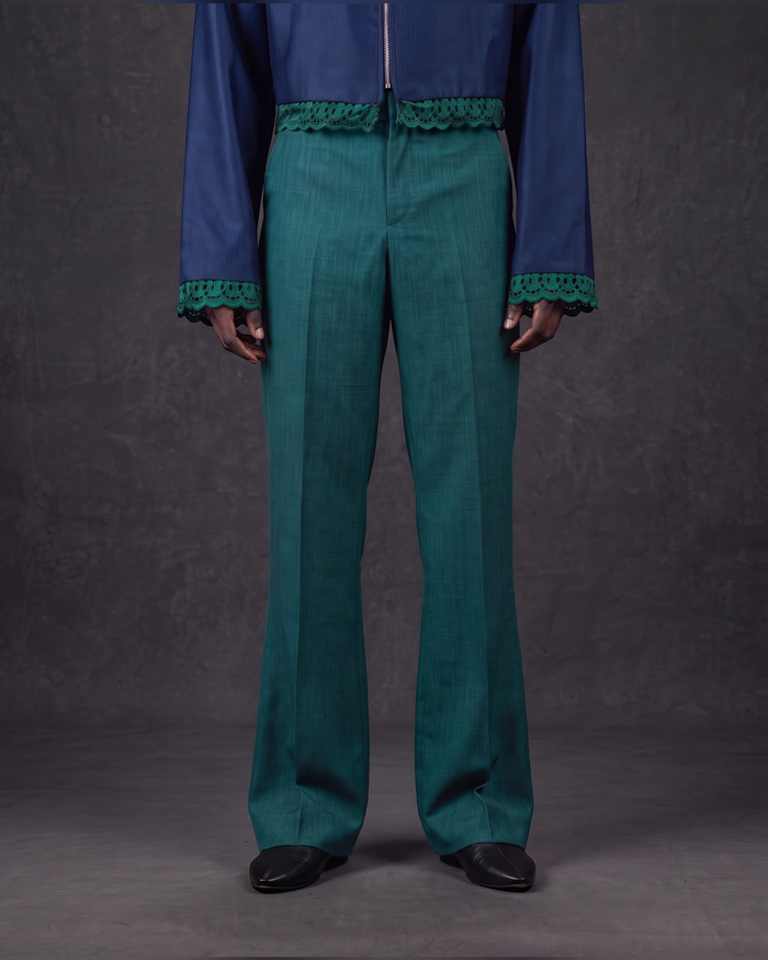 Emerald dress trousers worn with the cropped navy zip jacket, lower body view