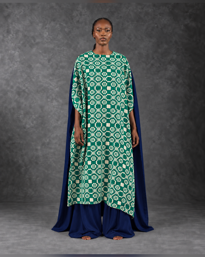 Model wearing the Kaleidoscope kaftan in emerald and cream with a navy cape layer, front view